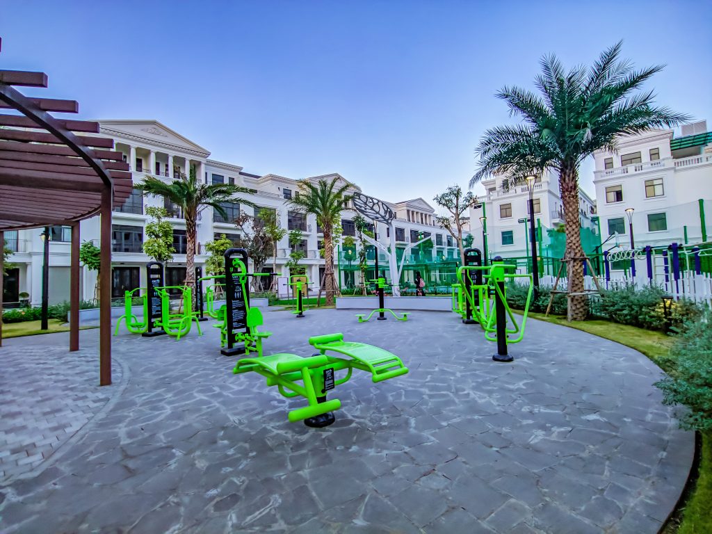 Outdoor fitness equipment installed along a park walkway