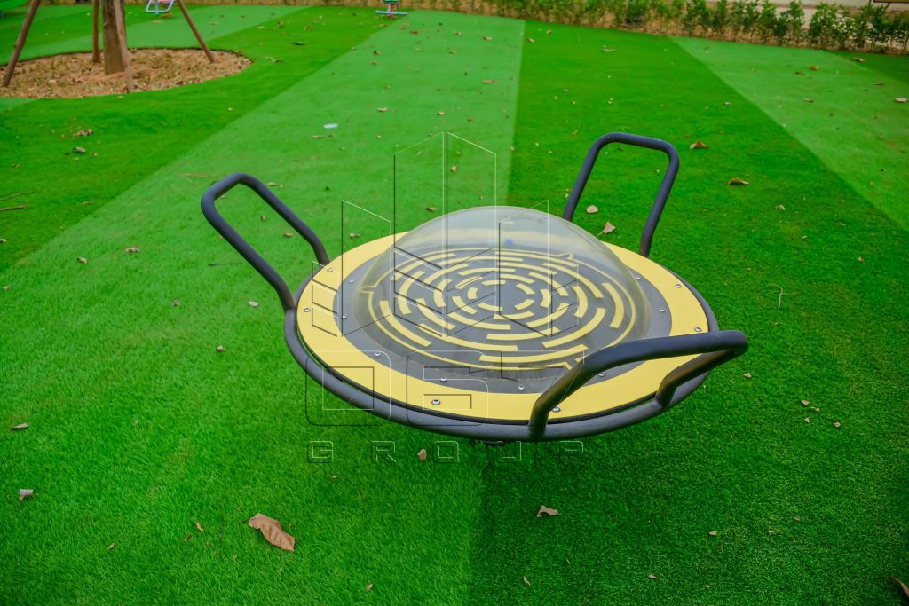 Rotating play dish on artificial grass surfacing